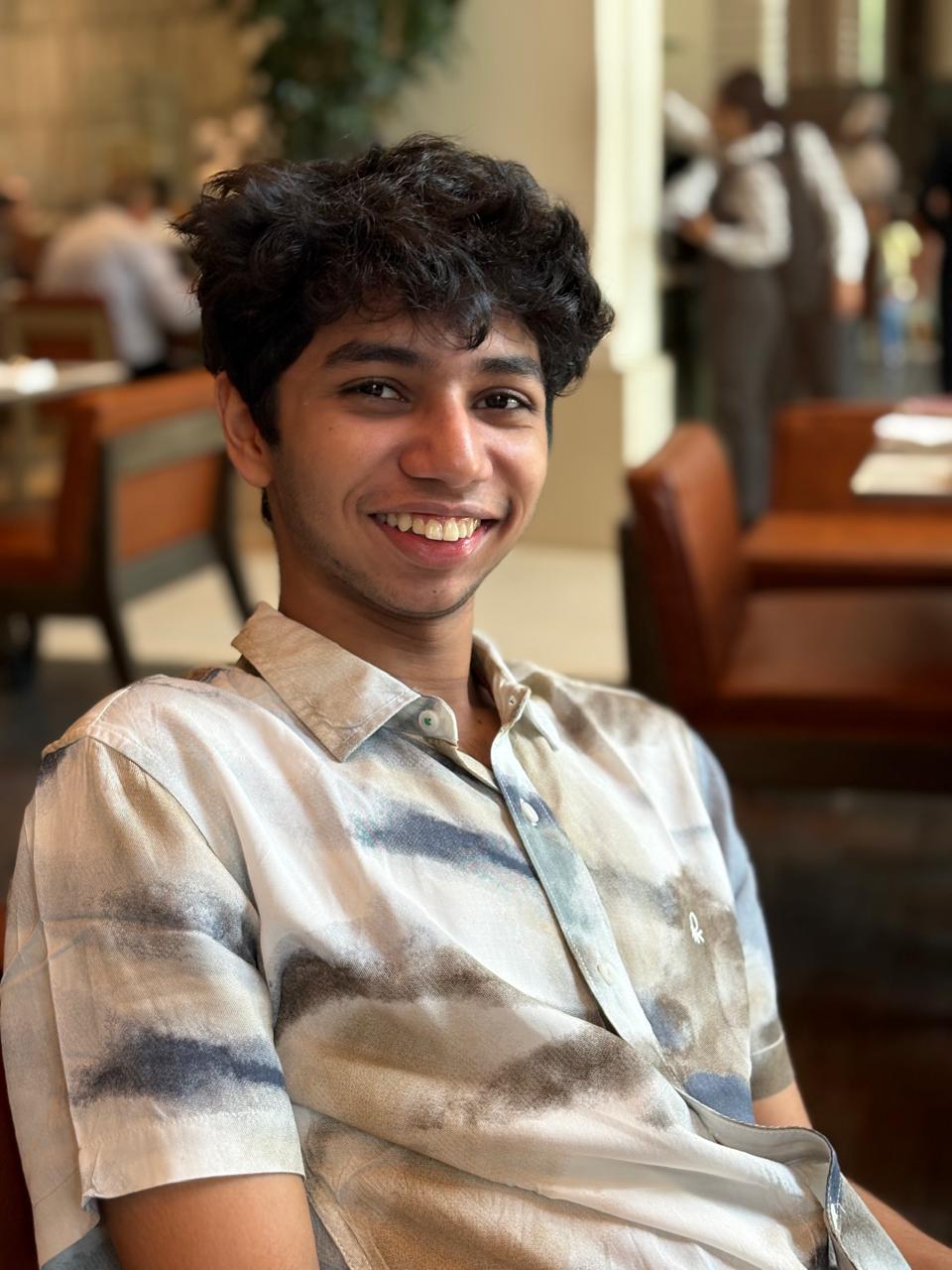 Portrait of a creator in an oatmeal linen shirt against a warm minimalist background